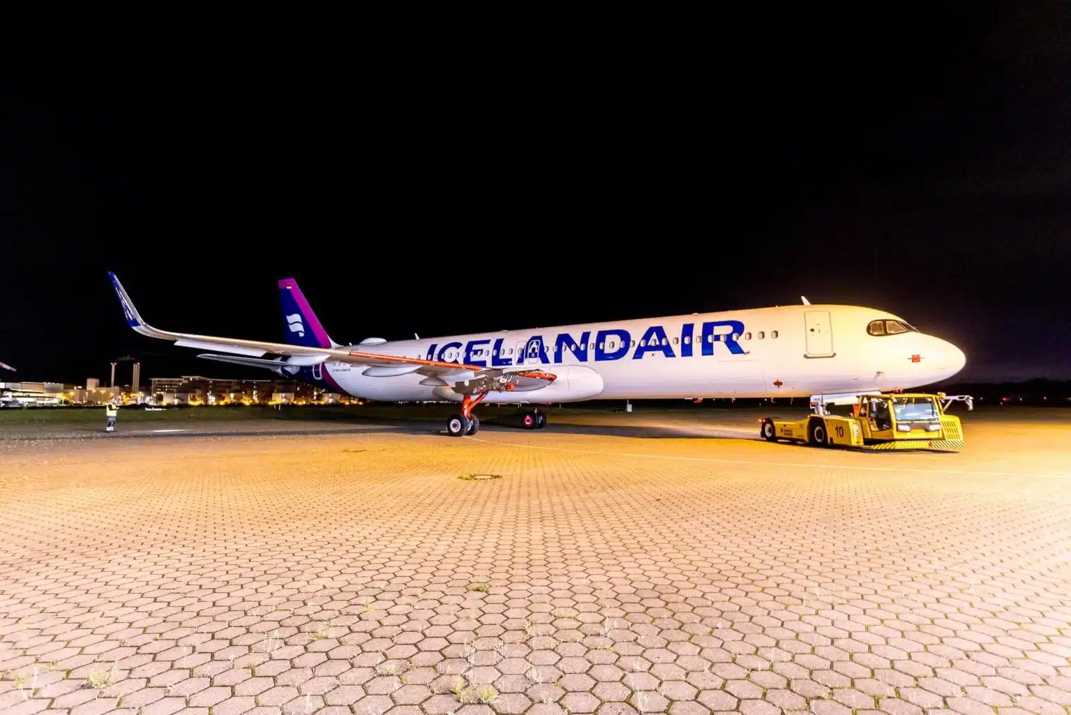 icelandair airbus a321lr being pulled into the ramp area.