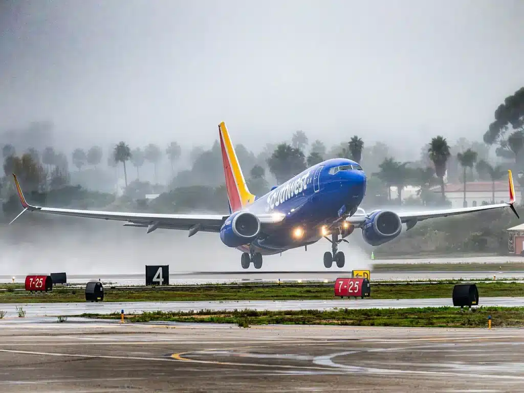 Southwest Airlines Boeing 737 MAX performing a rainy takeoff.